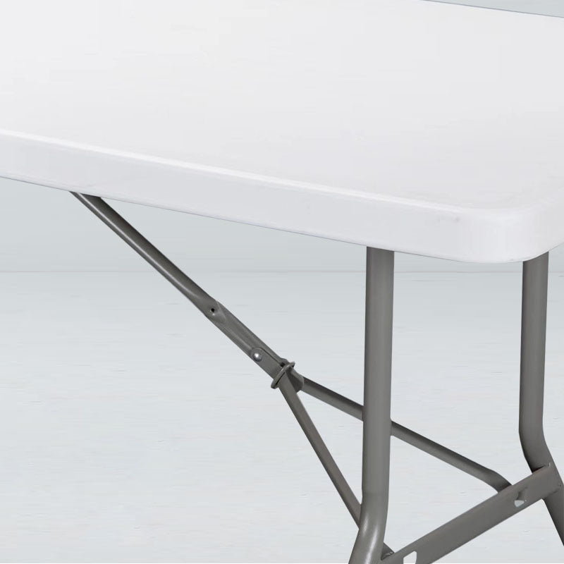 Folding banquet table detail showing durable white plastic top and sturdy steel legs for special events.