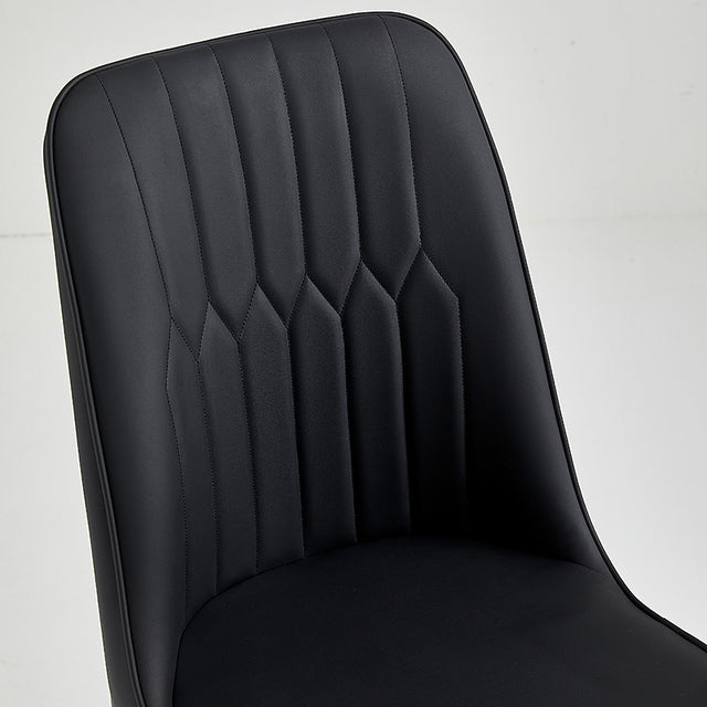 Close-up of a black restaurant chair with box-stitched vinyl upholstery and sleek design.