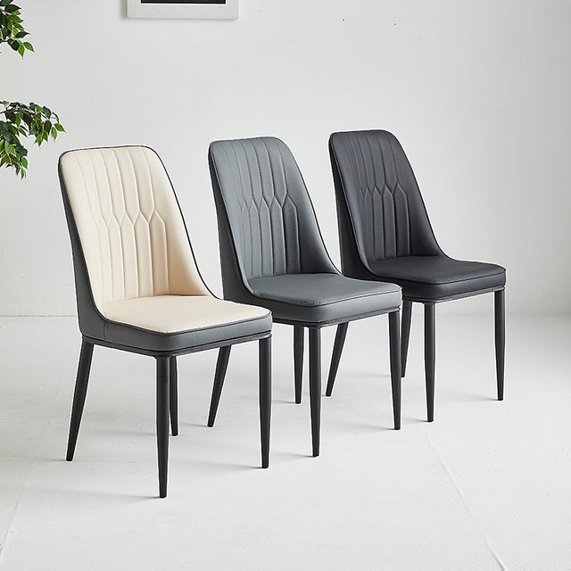 Set of three stylish restaurant chairs in cream, gray, and black upholstery with sleek black legs.