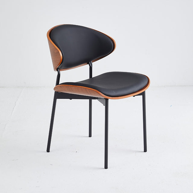 Commercial-grade black restaurant chair with wood accent and durable vinyl upholstery, ideal for heavy use.