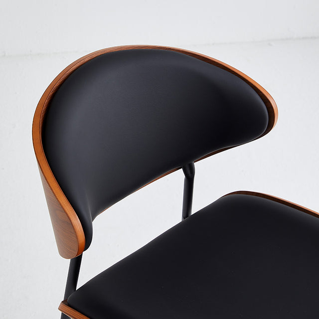 Top view of black restaurant chair featuring wood accents and comfortable vinyl upholstery, ideal for commercial use.