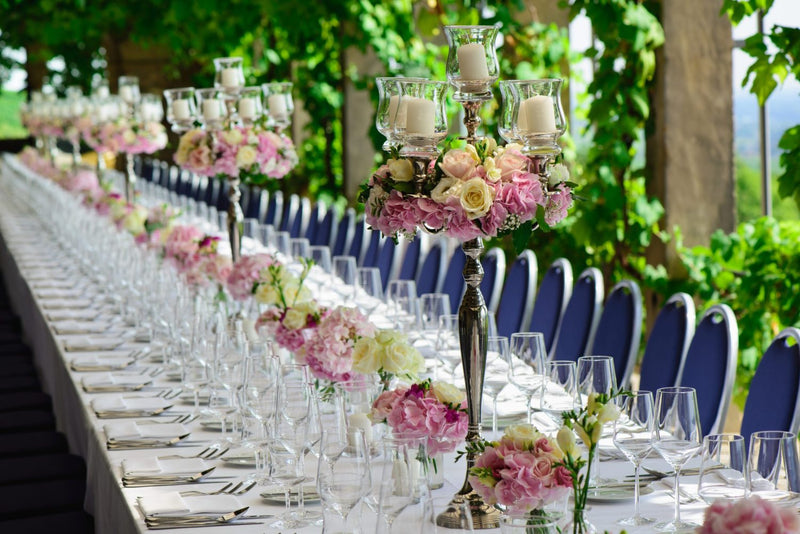 Folding banquet table detail showing durable white plastic top and sturdy steel legs for special events. outdoor
